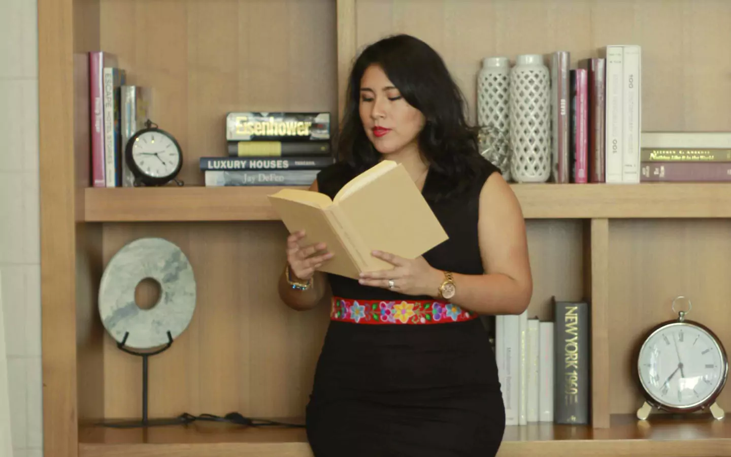 Vanessa reading a book in a professional setting